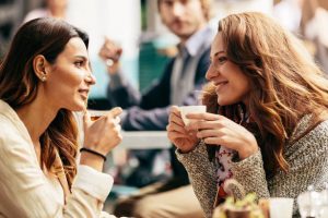 two-friends-talking-and-drinking-coffee